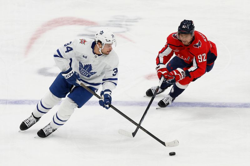 Oct 24, 2023; Washington, District of Columbia, USA; Toronto Maple Leafs center Auston Matthews (34) skates with the puck as Washington Capitals center Evgeny Kuznetsov (92) chases in the first period at Capital One Arena. Mandatory Credit: Geoff Burke-USA TODAY Sports