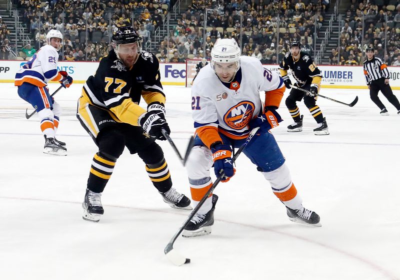 Mar 9, 2023; Pittsburgh, Pennsylvania, USA;  New York Islanders center Kyle Palmieri (21) moves the puck against Pittsburgh Penguins center Jeff Carter (77) during the first period at PPG Paints Arena. Mandatory Credit: Charles LeClaire-USA TODAY Sports