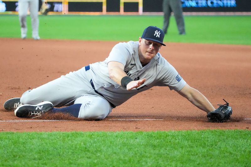 Jun 10, 2024; Kansas City, Missouri, USA; New York Yankees first baseman DJ LeMahieu (26) stops a line drive down the first base line against the Kansas City Royals in the fifth inning at Kauffman Stadium. Mandatory Credit: Denny Medley-USA TODAY Sports