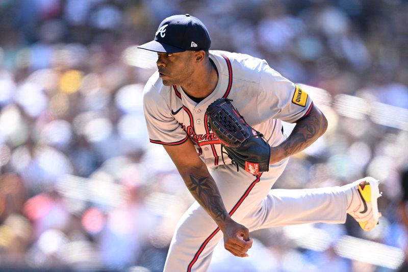 Jul 14, 2024; San Diego, California, USA; Atlanta Braves relief pitcher Raisel Iglesias (26) pitches against the San Diego Padres during the ninth inning at Petco Park. Mandatory Credit: Orlando Ramirez-USA TODAY Sports