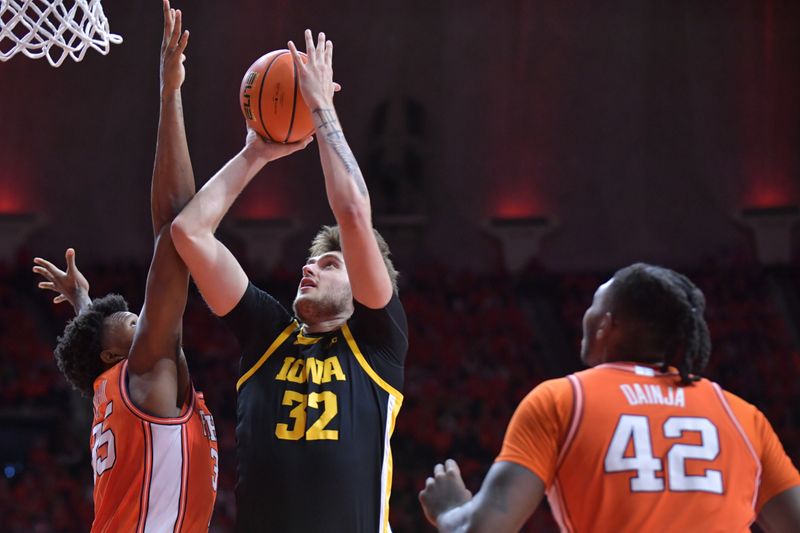 Feb 24, 2024; Champaign, Illinois, USA;  Iowa Hawkeyes forward Owen Freeman (32) drives to the basket as Illinois Fighting Illini forward Amani Hansberry (35) defends during the second half at State Farm Center. Mandatory Credit: Ron Johnson-USA TODAY Sports