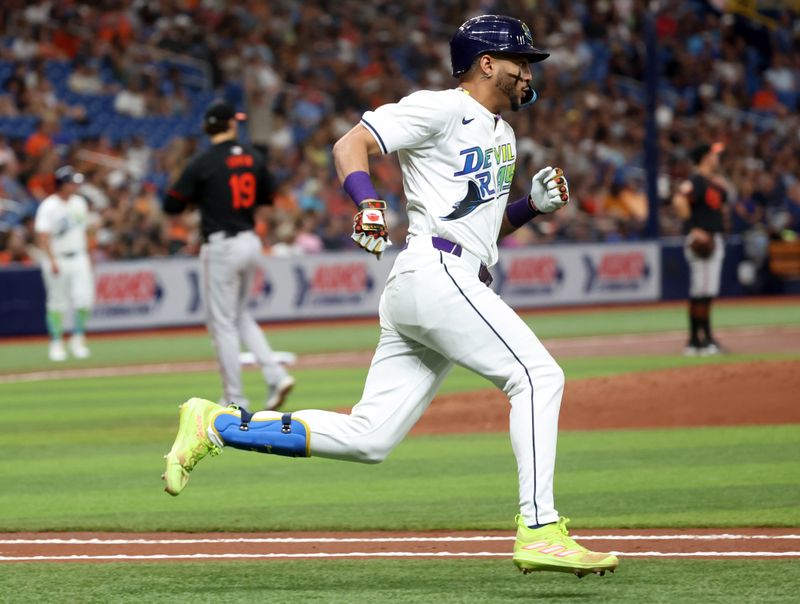 Jun 7, 2024; St. Petersburg, Florida, USA; Tampa Bay Rays outfielder Jose Siri (22) hits a home run against the Baltimore Orioles during the second inning at Tropicana Field. Mandatory Credit: Kim Klement Neitzel-USA TODAY Sports