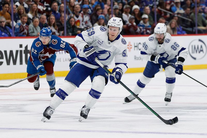 Oct 30, 2024; Denver, Colorado, USA; Tampa Bay Lightning center Jake Guentzel (59) controls the puck in the first period against the Colorado Avalanche at Ball Arena. Mandatory Credit: Isaiah J. Downing-Imagn Images