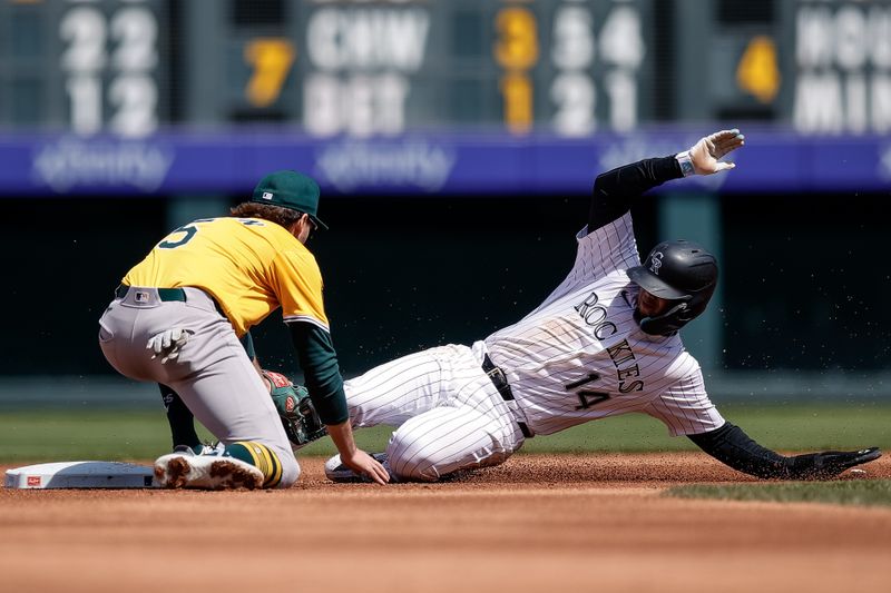 Apr 6, 2025; Denver, Colorado, USA; Colorado Rockies shortstop Ezequiel Tovar (14) steals second against Athletics shortstop Jacob Wilson (5) in the first inning at Coors Field. Mandatory Credit: Isaiah J. Downing-Imagn Images