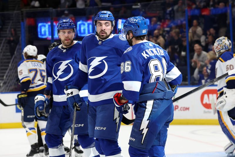 Dec 19, 2023; Tampa, Florida, USA; Tampa Bay Lightning right wing Nikita Kucherov (86) is congratulated after he scored during the first period against the St. Louis Blues at Amalie Arena. Mandatory Credit: Kim Klement Neitzel-USA TODAY Sports