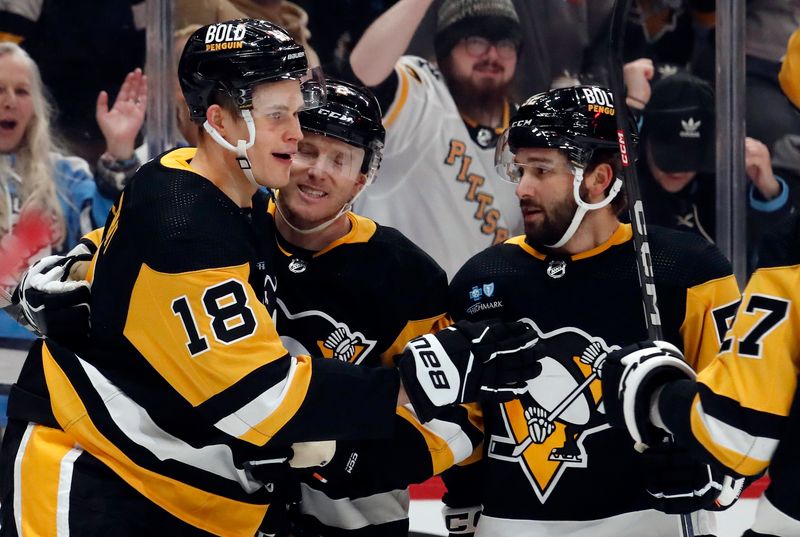 Mar 5, 2024; Pittsburgh, Pennsylvania, USA; Pittsburgh Penguins right wing Jesse Puljujarvi (18) celebrates his goal with defenseman Chad Ruhwedel (middle) and right wing Emil Bemstrom (right) against the Columbus Blue Jackets during the first period at PPG Paints Arena. Mandatory Credit: Charles LeClaire-USA TODAY Sports