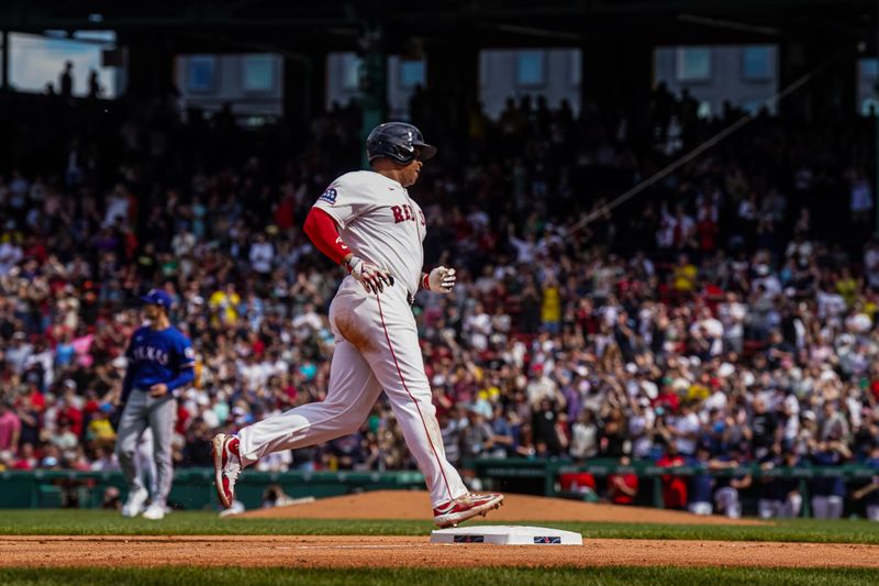 May 8, 2025; Boston, Massachusetts, USA; Boston Red Sox designated hitter Rafael Devers (11) hits a home run against the Texas Rangers in the seventh inning at Fenway Park. Mandatory Credit: David Butler II-Imagn Images