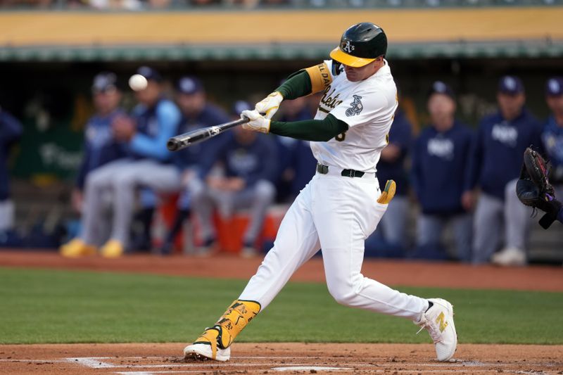 Aug 21, 2024; Oakland, California, USA; Oakland Athletics center fielder JJ Bleday (33) hits a home run against the Tampa Bay Rays during the first inning at Oakland-Alameda County Coliseum. Mandatory Credit: Darren Yamashita-USA TODAY Sports
