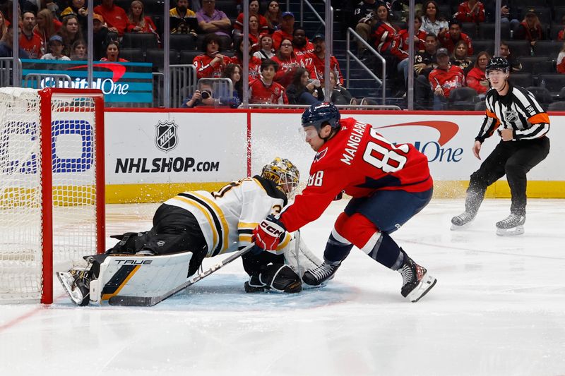 Oct 5, 2024; Washington, District of Columbia, USA; Boston Bruins goaltender Brandon Bussi (30) makes a save on Washington Capitals left wing Andrew Mangiapane (88) in the third period at Capital One Arena. Mandatory Credit: Geoff Burke-Imagn Images