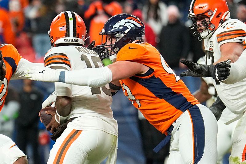 Cleveland Browns quarterback PJ Walker, left, is sacked in the end zone by Denver Broncos defensive end Zach Allen, right, during the second half of an NFL football game on Sunday, Nov. 26, 2023, in Denver. (AP Photo/Jack Dempsey)