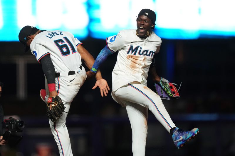 Jul 24, 2024; Miami, Florida, USA;  Miami Marlins center fielder Jazz Chisholm Jr. (2) and second baseman Otto Lopez (61) celebrate a victory over the Baltimore Orioles at loanDepot Park. Mandatory Credit: Jim Rassol-USA TODAY Sports