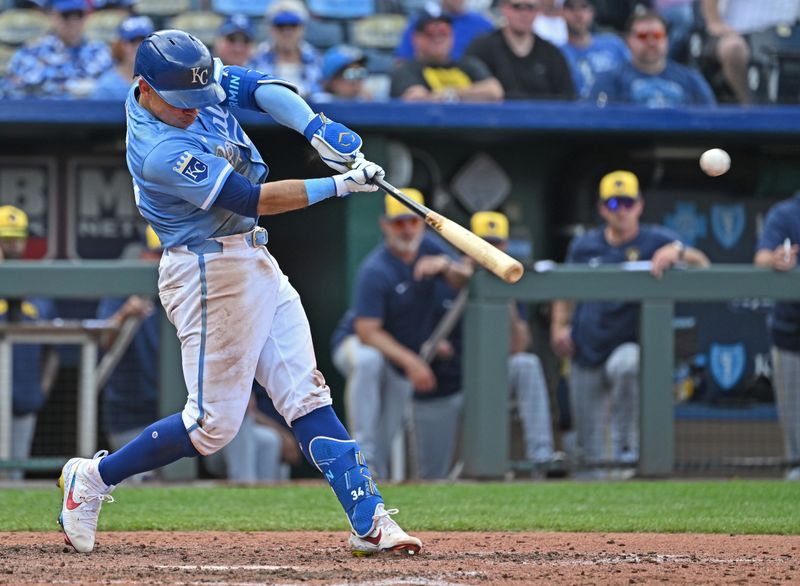 May 8, 2024; Kansas City, Missouri, USA;  Kansas City Royals catcher Freddy Fermin (34) hits an RBI single in the eighth inning against the Milwaukee Brewers at Kauffman Stadium. Mandatory Credit: Peter Aiken-USA TODAY Sports