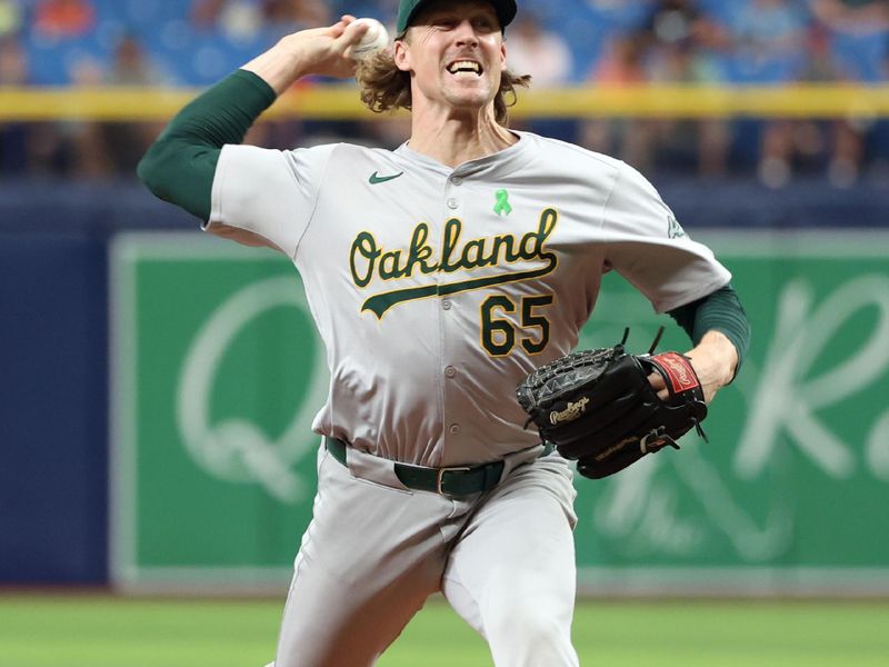 May 30, 2024; St. Petersburg, Florida, USA; Oakland Athletics relief pitcher Tyler Ferguson (65) throws a pitch during the tenth inning against the Tampa Bay Rays at Tropicana Field. Mandatory Credit: Kim Klement Neitzel-USA TODAY Sports