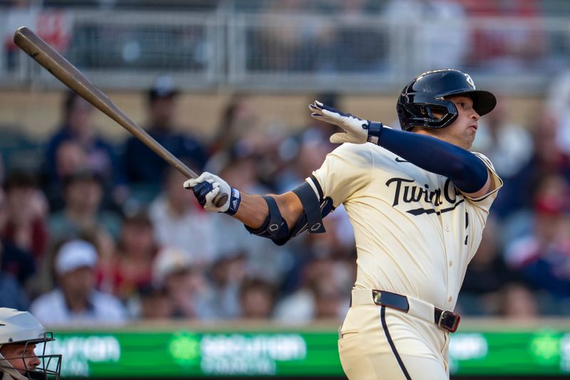 May 7, 2025; Minneapolis, Minnesota, USA; Minnesota Twins third baseman Brooks Lee (2) hits a single against the Baltimore Orioles in the fourth inning at Target Field. Mandatory Credit: Jesse Johnson-Imagn Images