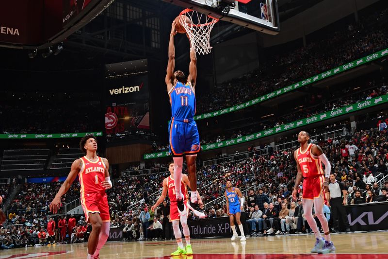 ATLANTA, GA - JANUARY 3: Isaiah Joe #11 of the Oklahoma City Thunder drives to the basket during the game against the Atlanta Hawks on January 3, 2024 at State Farm Arena in Atlanta, Georgia.  NOTE TO USER: User expressly acknowledges and agrees that, by downloading and/or using this Photograph, user is consenting to the terms and conditions of the Getty Images License Agreement. Mandatory Copyright Notice: Copyright 2024 NBAE (Photo by Scott Cunningham/NBAE via Getty Images)