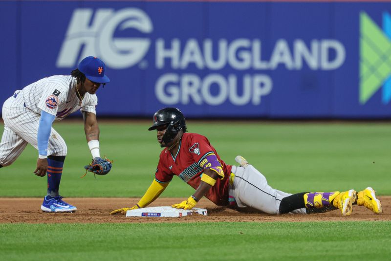 Apr 29, 2025; New York City, New York, USA; Arizona Diamondbacks shortstop Geraldo Perdomo (2) slides in to second base for a double as New York Mets second baseman Luisangel Acuna (2) tags during the third inning at Citi Field. Mandatory Credit: Vincent Carchietta-Imagn Images