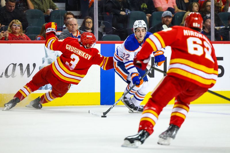 Sep 23, 2024; Calgary, Alberta, CAN; Edmonton Oilers center Matt Savoie (22) controls the puck against the Calgary Flames during the first period at Scotiabank Saddledome. Mandatory Credit: Sergei Belski-Imagn Images