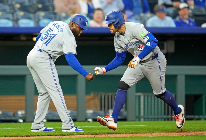 Apr 24, 2024; Kansas City, Missouri, USA; Toronto Blue Jays outfielder George Springer (4) celebrates with third base coach Carlos Febles (51) after hitting a home run during the fifth inning against the Kansas City Royals at Kauffman Stadium. Mandatory Credit: Jay Biggerstaff-USA TODAY Sports