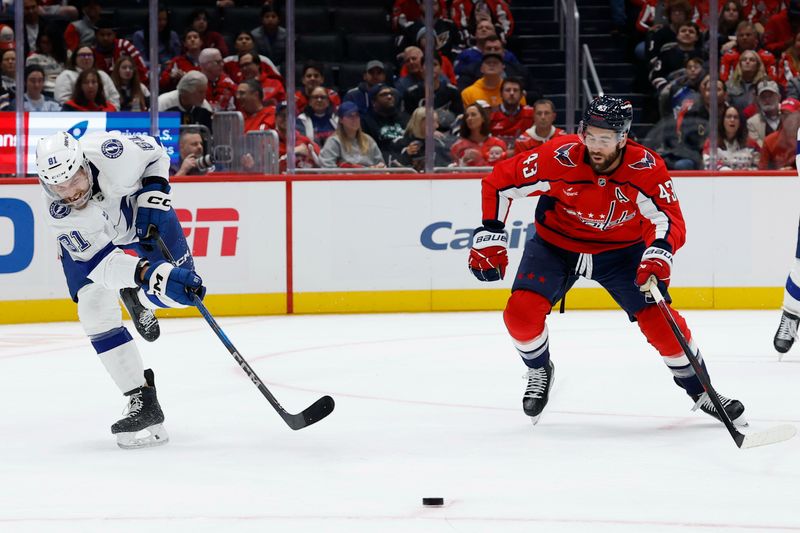 Oct 14, 2025; Washington, District of Columbia, USA; Tampa Bay Lightning defenseman Erik Cernak (81) passes the puck as Washington Capitals right wing Tom Wilson (43) chases in the first period at Capital One Arena. Mandatory Credit: Geoff Burke-Imagn Images