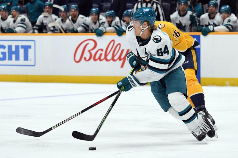 Mar 19, 2024; Nashville, Tennessee, USA; San Jose Sharks center Mikael Granlund (64) skates with the puck against Nashville Predators left wing Cole Smith (36) during the first period at Bridgestone Arena. Mandatory Credit: Christopher Hanewinckel-USA TODAY Sports