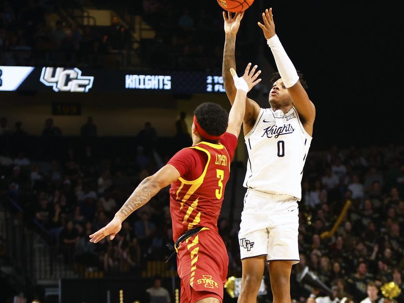 Feb 11, 2025; Orlando, Florida, USA;  Central Florida Knights guard Jordan Ivy-Curry (0) takes a jump shot as Iowa State Cyclones guard Tamin Lipsey (3) defends at Addition Financial Arena. Mandatory Credit: Russell Lansford-Imagn Images