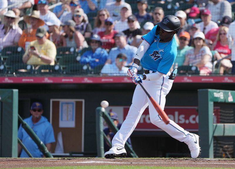 Mar 11, 2023; Jupiter, Florida, USA;  Miami Marlins center fielder Jazz Chisholm Jr. (2) hits a single in the first inning against the Tampa Bay Rays at Roger Dean Stadium. Mandatory Credit: Jim Rassol-USA TODAY Sports