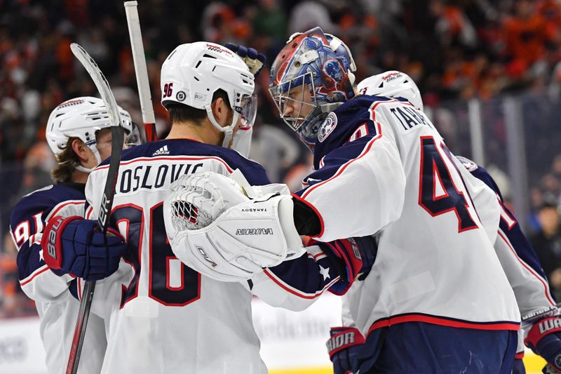 Jan 4, 2024; Philadelphia, Pennsylvania, USA; Columbus Blue Jackets goaltender Daniil Tarasov (40) and center Jack Roslovic (96) celebrate shootout win with teammates against the Philadelphia Flyers at Wells Fargo Center. Mandatory Credit: Eric Hartline-USA TODAY Sports