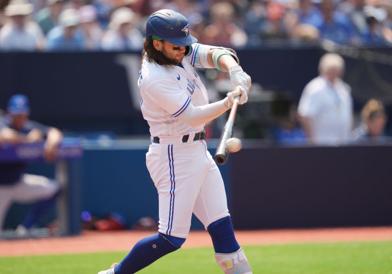 Jul 16, 2023; Toronto, Ontario, CAN; Toronto Blue Jays shortstop Bo Bichette (11) hits a single against the Arizona Diamondbacks during the fifth inning at Rogers Centre. Mandatory Credit: Nick Turchiaro-USA TODAY Sports