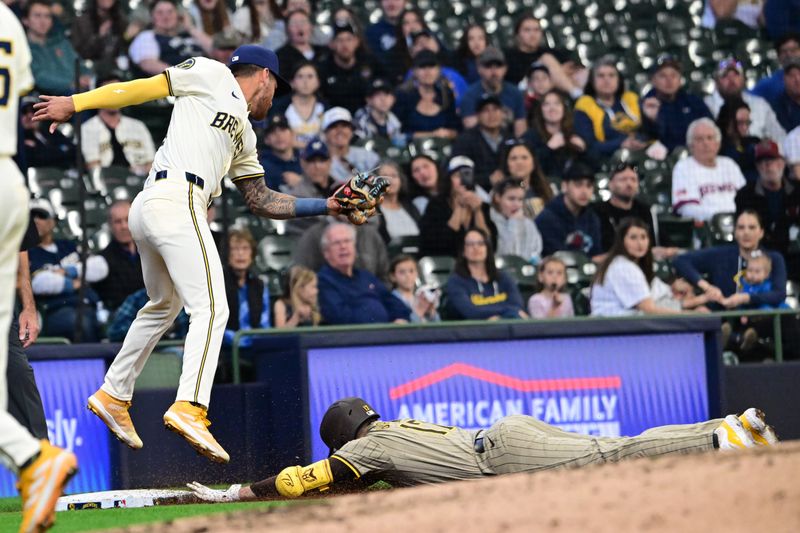 Apr 17, 2024; Milwaukee, Wisconsin, USA; San Diego Padres third baseman Matthew Batten (17) slides into third base with a triple before tag by Milwaukee Brewers third baseman Oliver Dunn (15) in the eighth inning at American Family Field. Mandatory Credit: Benny Sieu-USA TODAY Sports