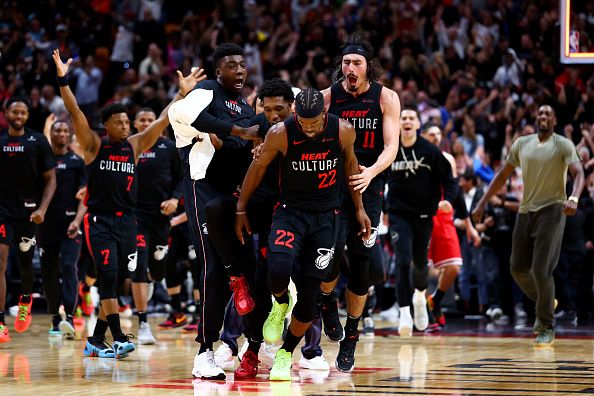 MIAMI, FLORIDA - DECEMBER 16: Jimmy Butler #22 of the Miami Heat celebrates with teammates after hitting a buzzer beater against the Chicago Bulls at Kaseya Center on December 16, 2023 in Miami, Florida. NOTE TO USER: User expressly acknowledges and agrees that, by downloading and or using this photograph, User is consenting to the terms and conditions of the Getty Images License Agreement. (Photo by Megan Briggs/Getty Images)