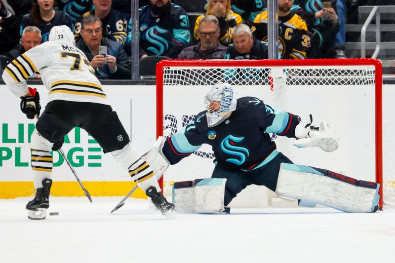 Feb 26, 2024; Seattle, Washington, USA; Seattle Kraken goaltender Philipp Grubauer (31) defends the net against Boston Bruins defenseman Charlie McAvoy (73) during an overtime shootout at Climate Pledge Arena. Mandatory Credit: Joe Nicholson-USA TODAY Sports