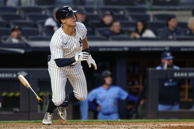 Apr 27, 2025; Bronx, New York, USA; New York Yankees shortstop Anthony Volpe (11) singles during the eighth inning against the Toronto Blue Jays at Yankee Stadium. Mandatory Credit: Vincent Carchietta-Imagn Images