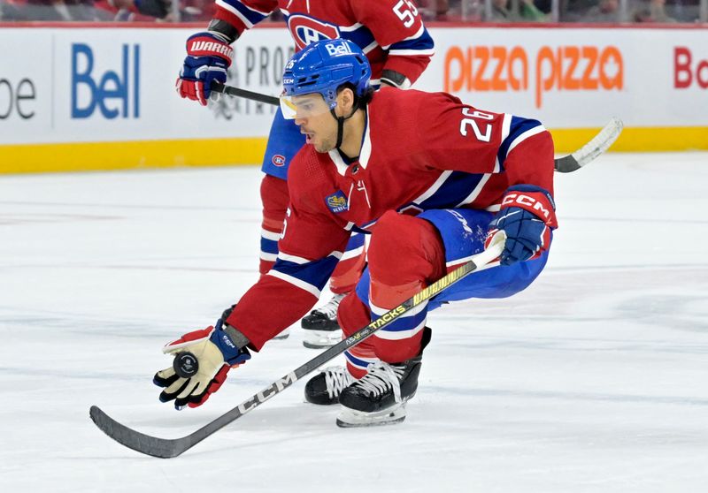 Feb 11, 2024; Montreal, Quebec, CAN;  Montreal Canadiens defenseman Johnathan Kovacevic (26) intercepts a pass with his glove during the third period against the St.Louis Blues at the Bell Centre. Mandatory Credit: Eric Bolte-USA TODAY Sports