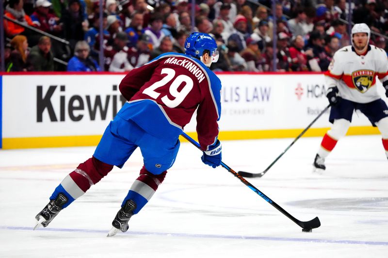 Jan 6, 2025; Denver, Colorado, USA; Colorado Avalanche center Nathan MacKinnon (29) skates with the puck during a power play in the first period against the Florida Panthers at Ball Arena. Mandatory Credit: Ron Chenoy-Imagn Images