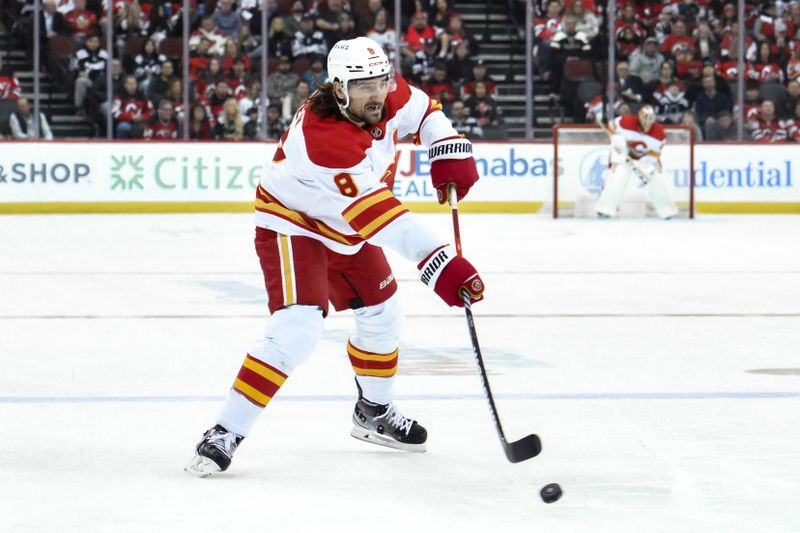 Feb 8, 2024; Newark, New Jersey, USA; Calgary Flames defenseman Chris Tanev (8) passes the puck during the first period against the New Jersey Devils at Prudential Center. Mandatory Credit: John Jones-USA TODAY Sports