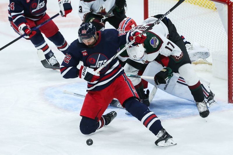 Nov 18, 2023; Winnipeg, Manitoba, CAN;  Winnipeg Jets forward Nino Niederreiter (62) jostles for position with Arizona Coyotes forward Nick Bjugstad (17) during the third period at Canada Life Centre. Mandatory Credit: Terrence Lee-USA TODAY Sports