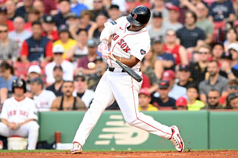 Jun 25, 2024; Boston, Massachusetts, USA; Boston Red Sox third baseman Rafael Devers (11) hits a solo home run against the Toronto Blue Jays during the second inning at Fenway Park. Mandatory Credit: Brian Fluharty-USA TODAY Sports