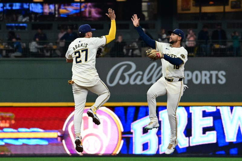 Apr 17, 2024; Milwaukee, Wisconsin, USA;  Milwaukee Brewers shortstop Willy Adames (27) and center fielder Blake Perkins (16) celebrate after beating the San Diego Padres at American Family Field. Mandatory Credit: Benny Sieu-USA TODAY Sports