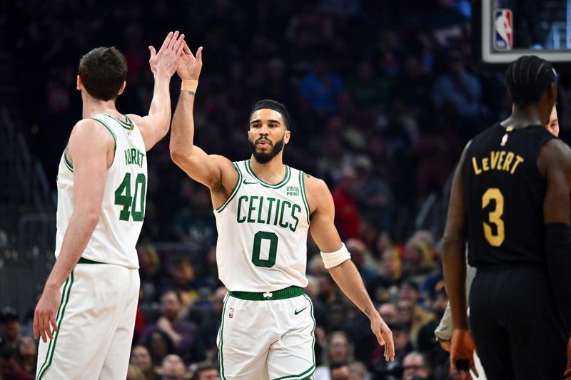 CLEVELAND, OHIO - MARCH 05: Luke Kornet #40 celebrates with Jayson Tatum #0 during the first half against the Cleveland Cavaliers at Rocket Mortgage Fieldhouse on March 05, 2024 in Cleveland, Ohio. NOTE TO USER: User expressly acknowledges and agrees that, by downloading and or using this photograph, User is consenting to the terms and conditions of the Getty Images License Agreement. (Photo by Jason Miller/Getty Images)