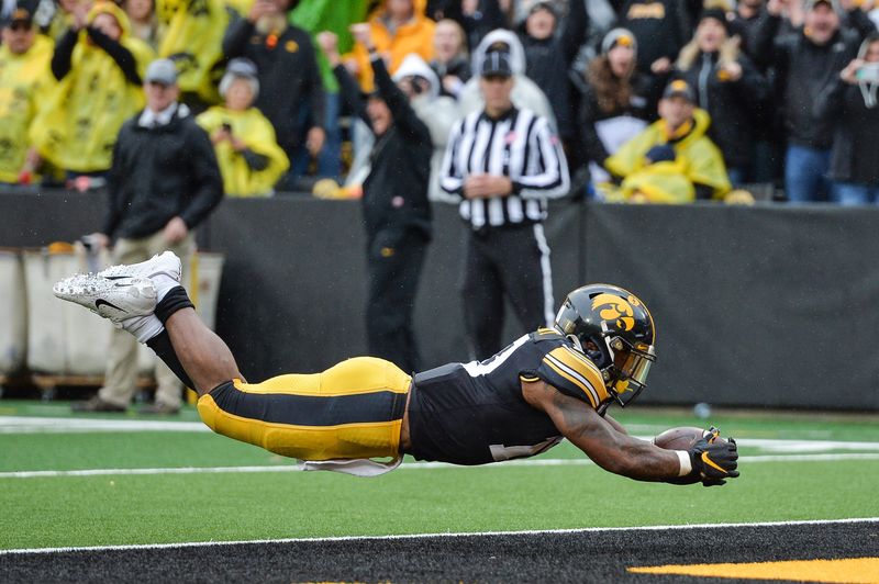 Oct 19, 2019; Iowa City, IA, USA; Iowa Hawkeyes running back Mekhi Sargent (10) leaps into the end zone to score a touchdown against the Purdue Boilermakers during the fourth quarter at Kinnick Stadium. Mandatory Credit: Jeffrey Becker-USA TODAY Sports