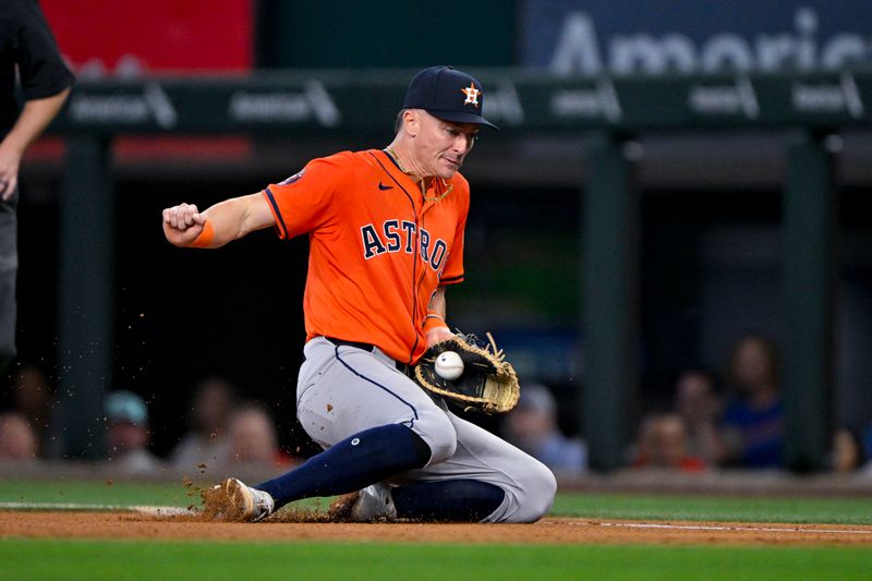 Aug 7, 2024; Arlington, Texas, USA;  Houston Astros first baseman Zach Dezenzo (9) fields a ball hit by Texas Rangers left fielder Josh Smith (8) during the fifth inning at Globe Life Field. Mandatory Credit: Jerome Miron-USA TODAY Sports