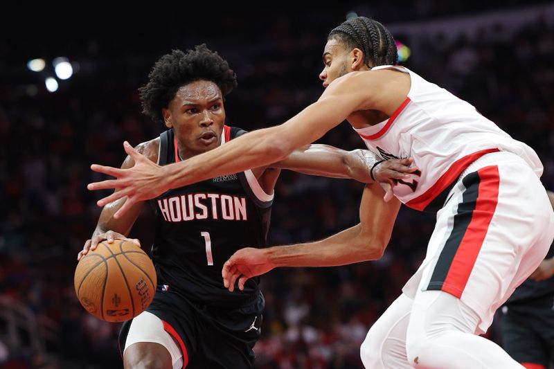 HOUSTON, TEXAS - NOVEMBER 22: Amen Thompson #1 of the Houston Rockets handles the ball as Rayan Rupert #21 of the Portland Trail Blazers defends during the second half in the NBA Emirates Cup at Toyota Center on November 22, 2024 in Houston, Texas.  NOTE TO USER: User expressly acknowledges and agrees that, by downloading and or using this photograph, User is consenting to the terms and conditions of the Getty Images License Agreement. (Photo by Alex Slitz/Getty Images)