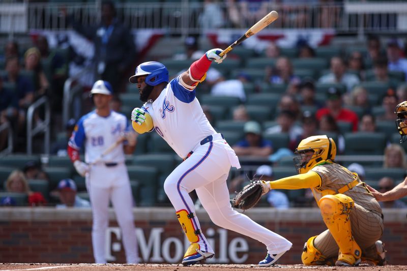 May 24, 2025; Atlanta, Georgia, USA; Atlanta Braves designated hitter Marcell Ozuna (20) hits a single against the San Diego Padres in the first inning at Truist Park. Mandatory Credit: Brett Davis-Imagn Images
