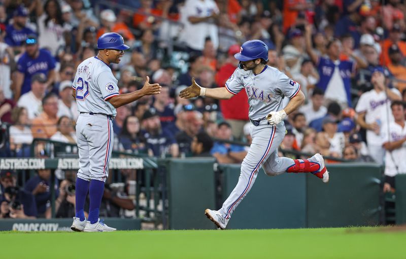 Jul 14, 2024; Houston, Texas, USA; Texas Rangers third baseman Josh Smith (8) celebrates with third base coach Tony Beasley (27) after hitting a home run during the eighth inning against the Houston Astros at Minute Maid Park. Mandatory Credit: Troy Taormina-USA TODAY Sports