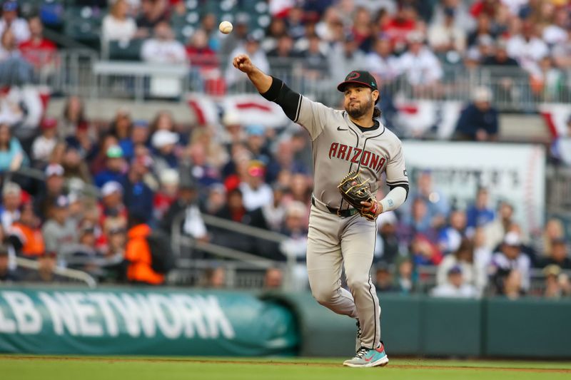 Apr 6, 2024; Atlanta, Georgia, USA; Arizona Diamondbacks third baseman Eugenio Suarez (28) throws a runner out at first against the Atlanta Braves in the first inning at Truist Park. Mandatory Credit: Brett Davis-USA TODAY Sports