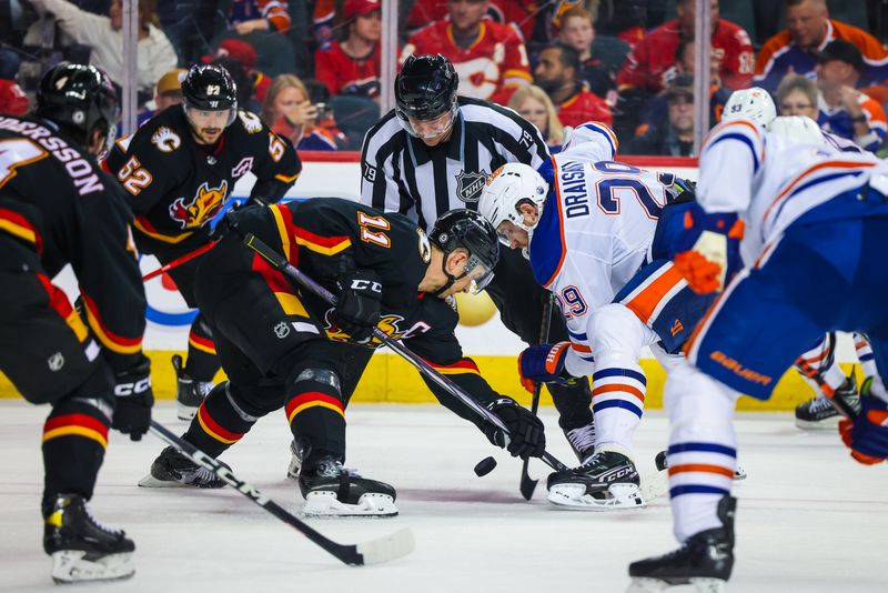 Apr 6, 2024; Calgary, Alberta, CAN; Calgary Flames center Mikael Backlund (11) and Edmonton Oilers center Leon Draisaitl (29) face off for the puck during the third period at Scotiabank Saddledome. Mandatory Credit: Sergei Belski-USA TODAY Sports