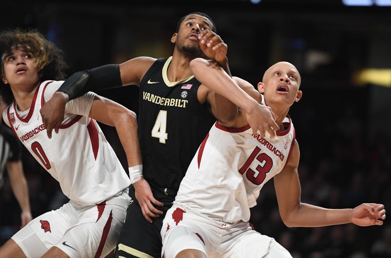 Jan 14, 2023; Nashville, Tennessee, USA; Vanderbilt Commodores guard Jordan Wright (4) battles with Arkansas Razorbacks guard Jordan Walsh (13) and guard Anthony Black (0) for a rebound during the first half at Memorial Gymnasium. Mandatory Credit: Christopher Hanewinckel-USA TODAY Sports