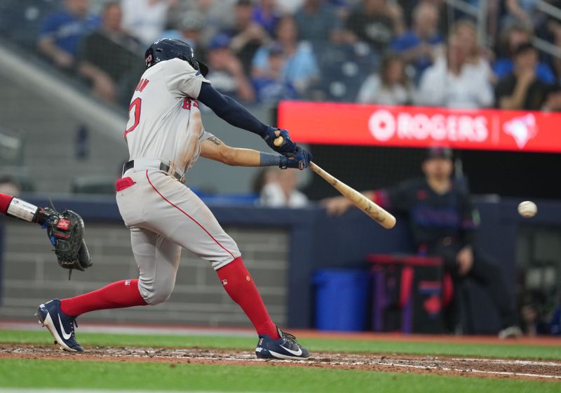 Jun 19, 2024; Toronto, Ontario, CAN; Boston Red Sox shortstop David Hamilton (70) hits a single against the Toronto Blue Jays during fifth inning at Rogers Centre. Mandatory Credit: Nick Turchiaro-USA TODAY Sports