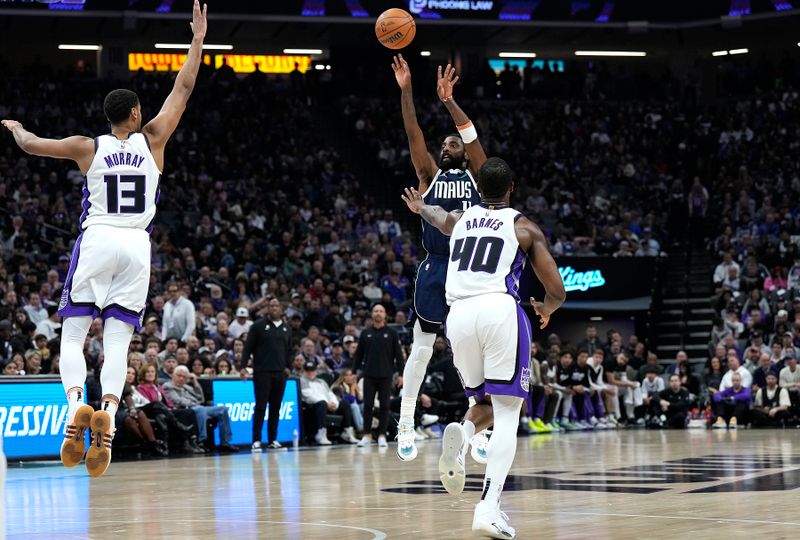 SACRAMENTO, CALIFORNIA - MARCH 29: Kyrie Irving #11 of the Dallas Mavericks shoot a three-point shot over Keegan Murray #13 and Harrison Barnes #40 of the Sacramento Kings during the first half at Golden 1 Center on March 29, 2024 in Sacramento, California. NOTE TO USER: User expressly acknowledges and agrees that, by downloading and or using this photograph, User is consenting to the terms and conditions of the Getty Images License Agreement. (Photo by Thearon W. Henderson/Getty Images)