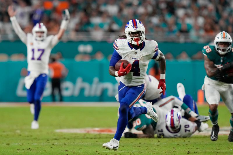 Buffalo Bills running back James Cook (4) runs for a touchdown during the first half of an NFL football game against the Miami Dolphins, Thursday, Sept. 12, 2024, in Miami Gardens, Fla. (AP Photo/Lynne Sladky)